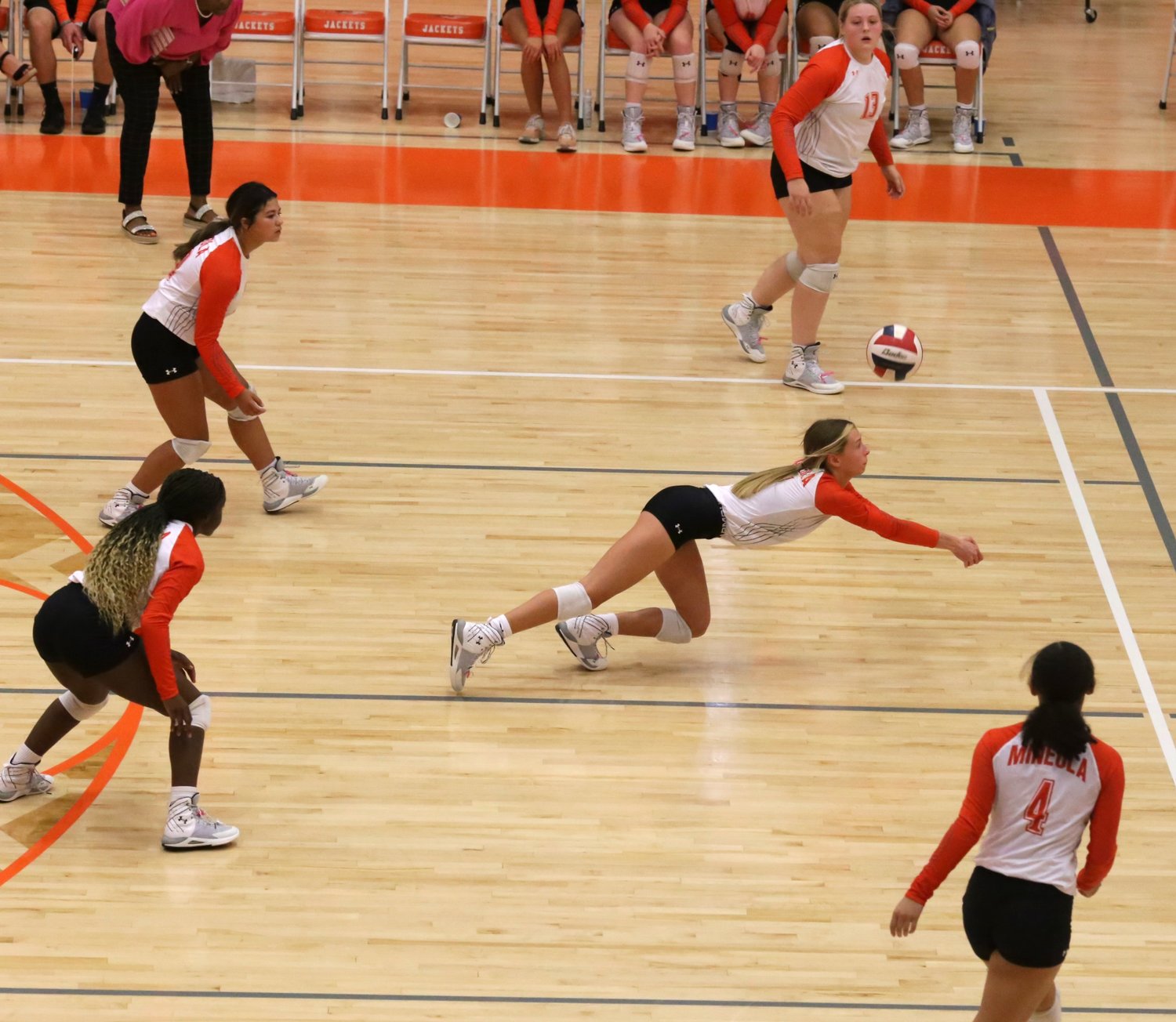 The Mineola defense secured the set one win against Harmony. Here Olivia Hughes digs a tough ball. The floor spacing of the Lady Jackets was spot-on.